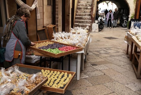 Bari, Italy, 27 November, 2023: woman pasta maker laying out her wares in the iconic Strada del