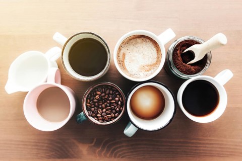Multiple coffee cups and multicolored mugs with americano, espresso, latte and cappuccino, milk