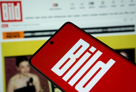 The logo of the German newspaper Bild is displayed on a smartphone screen, and the website bild.de