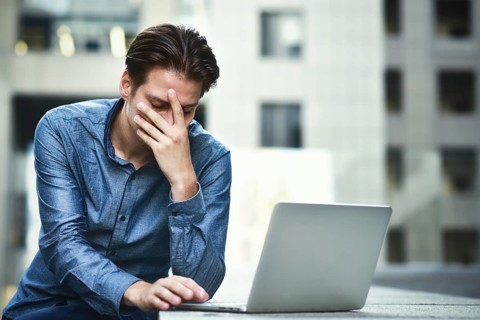 Stressed businessman after project failure. Confused young man frustrated by online problem