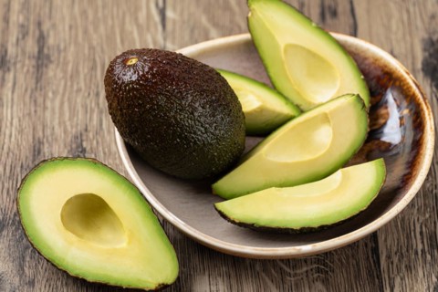 Avocado isolated on a wooden table
