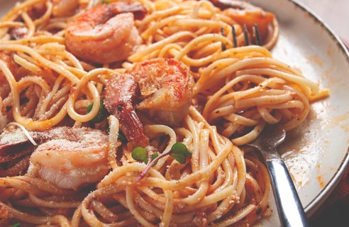 Spaghetti with tiger prawns, in tomato sauce, homemade, top view, no people