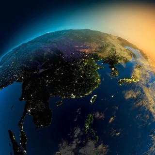 Night view of Asia from the satellite to the glowing lights of towns on the sunrise from the east