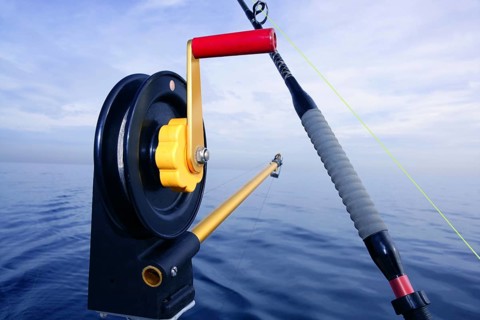 Downrigger angler fishing tackle with blue sea water background