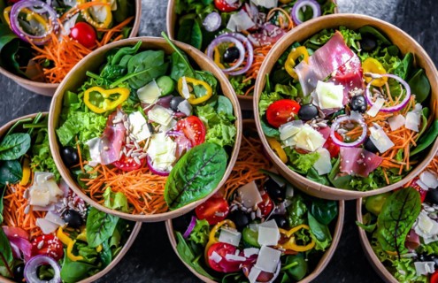 Round paper boxes with pre-packaged vegetable salads ready for sale