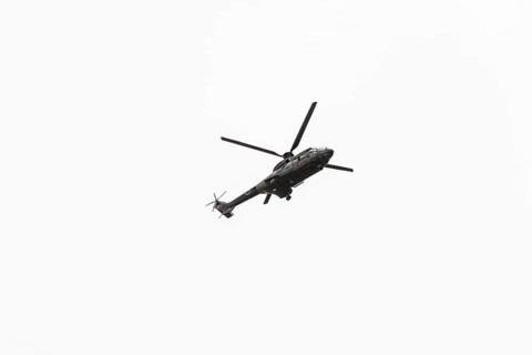 Photo of Military navy helicopter flying isolated on white background