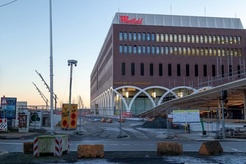 Construction site of the Westfield Hamburg-Überseequartier shopping centre in the evening light,