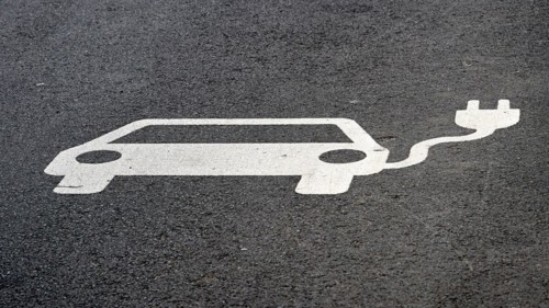 Indication of an electric charging station on the asphalt of a street in Leipzig