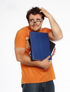 Young man in glasses holding bunch of books