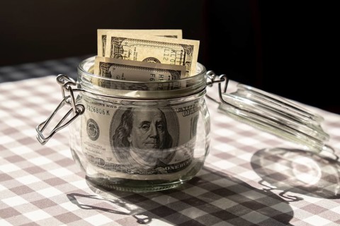 Dollar banknote saving money in glass jar. Consumption and economy Collecting money. Tips.