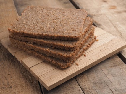 Wholemeal rye bread on a rustic wooden table, healthy food concept