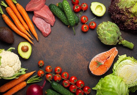 Assorted food raw products: vegetables, beef meat steak, fish salmon fillet on dark rustic brown
