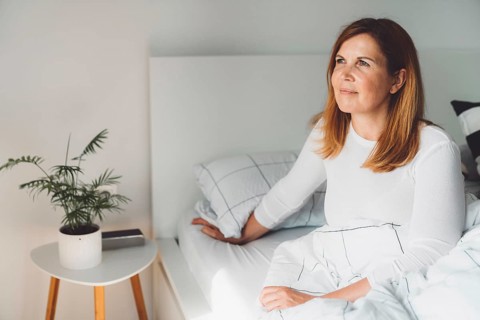 Cheerful happy caucasian woman relaxing at home on her day off work. Adult content woman spending