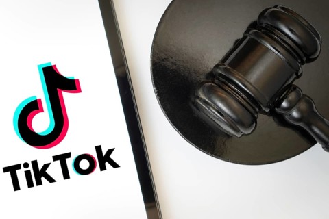 An iPad displays the tiktok logo alongside a judge's gavel