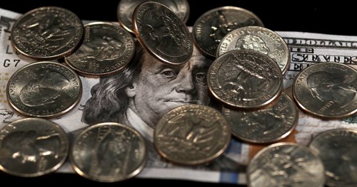 Quarter Dollar Coins Falling, Rolling and Sliding on Black Background