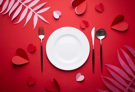 Romantic dinner at restaurant on Valentines day, paper art. White empty plate, spoon, fork, knife