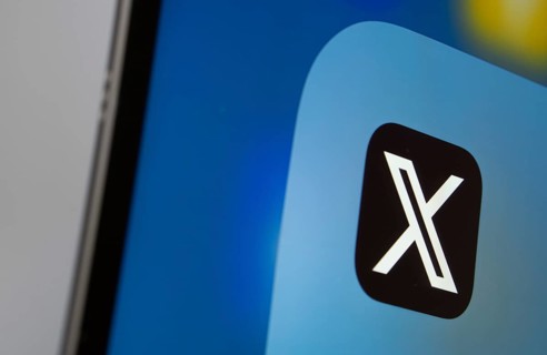 A close up of an iPad screen displaying the X (twitter) app