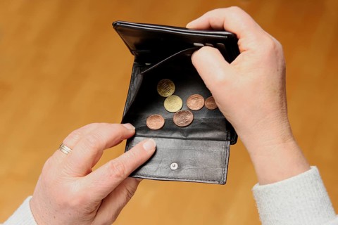 Woman shows her empty wallet