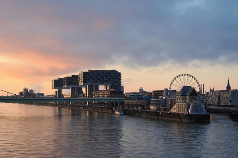 View over the Rhine with crane houses and Ferris wheel, sunrise, Cologne, Germany, Europe