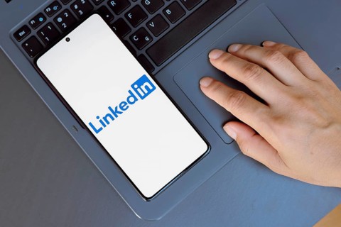 In this photo illustration, the LinkedIn logo is displayed on a smartphone screen
