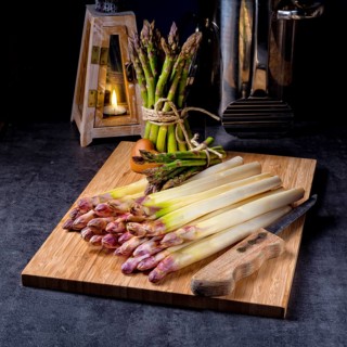 White and green asparagus on kitchen board