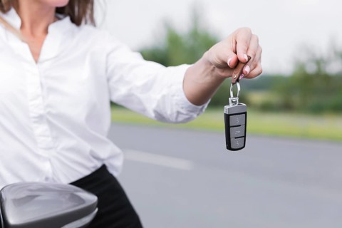 Close up woman holding car keys