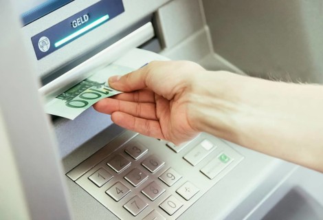 Young woman withdrawing money from a cash machine