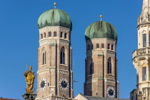 Towers of the Church of Our Lady and the golden statue of the Marian Column on Marienplatz, Munich,