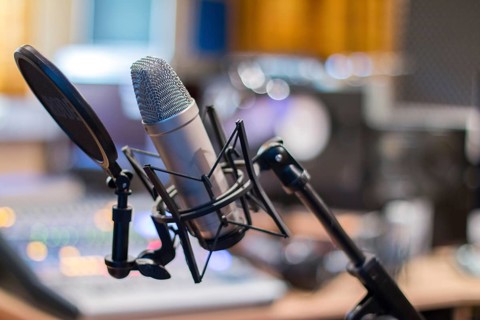 Professional studio microphone, recording studio, equipment in the blurry background
