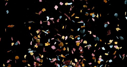 Confettis Falling against Black Background