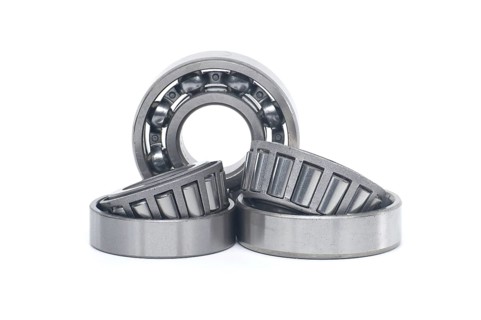Single row tapered roller bearings and deep groove ball bearing without seal isolated on white