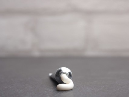 Close up of a cream tube on a bathroom table
