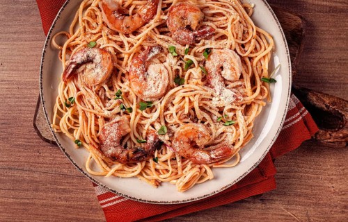 Spaghetti with tiger prawns, in tomato sauce, homemade, top view, no people