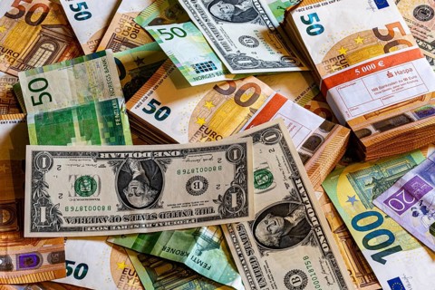 Banknotes, euro, US dollar, Norwegian krone and Swedish krona. Piles and bundles