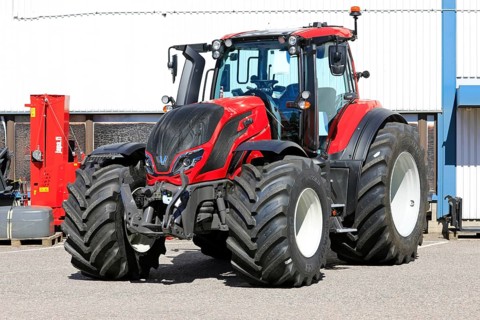 Red Valtra T235 tractor parked outside at the AGCO agricultural machinery dealership. Salo, Finland