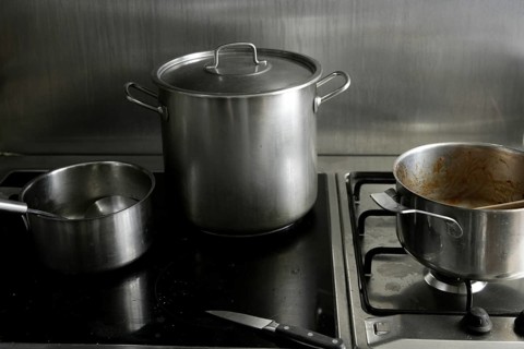 Dirty used stainless steel kitchen cooking stuff, pans