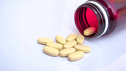Open Medicine Bottle with Scattered Pills, Pharmaceutical Healthcare Background, Close-up, Medical