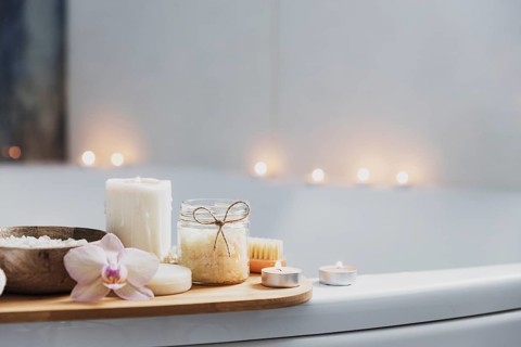 Preparation for hotel spa treatment or home bath procedure. White washbasin in bathroom with