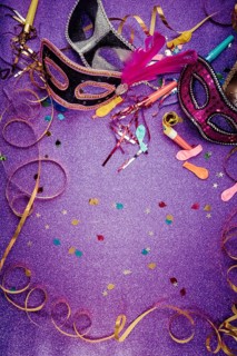 Carnival Mask, Streamers And Confetti For Festive Background in violet tone with copy space