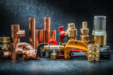 Pipe cutter and adjustable wrench with brass copper connectors big set on dark background