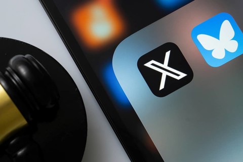 A close up of an iPad screen displaying the twitter (X) and bluesky app alongside a judge's gavel
