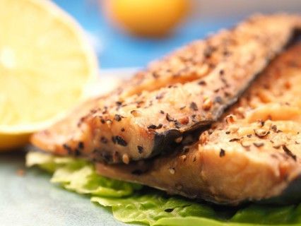 Tasty smoked mackerel garnished with pepper corns, selective focus