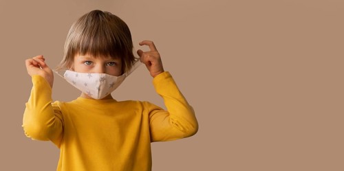 Boy wearing medical mask with copy space
