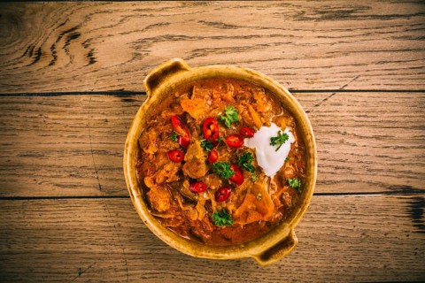 Hungarian Szegedin Goulash with pickled white cabbage (sauerkraut), onion and bread dumplings in