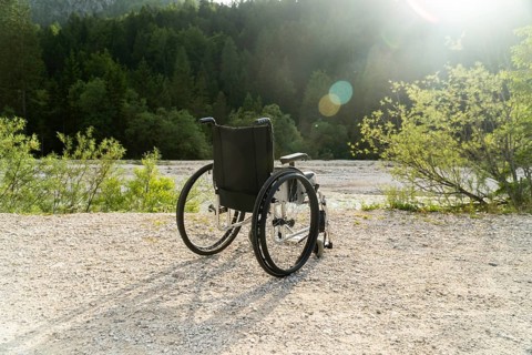 Photo of empty wheelchair parked in park, health care concept