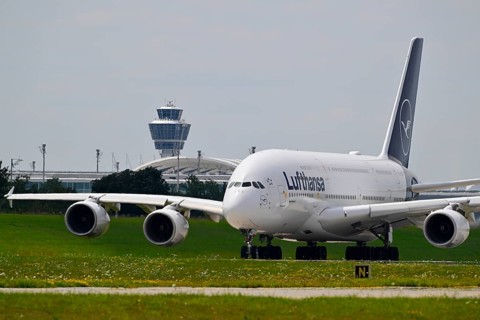 Lufthansa Airbus A380-800 with control tower taxiing from Terminal 2 to Runway North, Munich