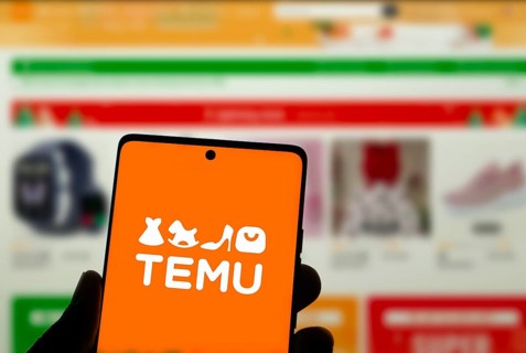 Temu logo online marketplace ecommerce on a smartphone and computer in Stuttgart, Germany.