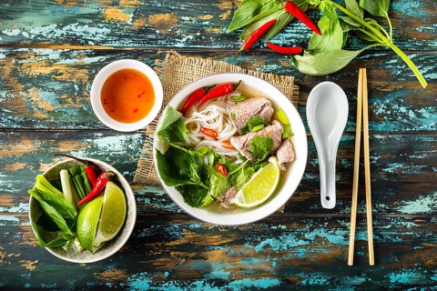 Traditional Vietnamese soup Pho bo with herbs, meat, rice noodles, broth. Pho bo in bowl with