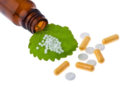 Homeopathy. Globules as an alternative medicine. Lying on a sheet, Homeopathy. Globules as