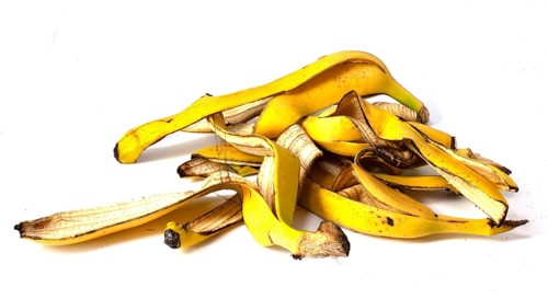 A pile of banana peels, organic fruit waste on a white background
